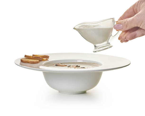 istock pour cream into mushroom cream soup 1182856750