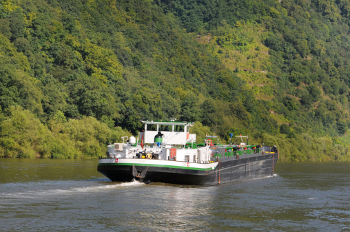 Barge with swiss flag on Mosel River (Germany)