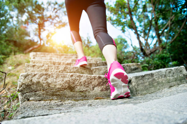 istock Woman feet walking on the steps 1182858671