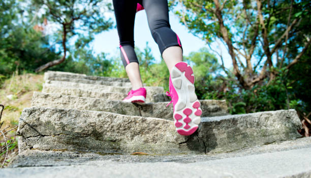 istock Woman feet walking on the steps 1182858793