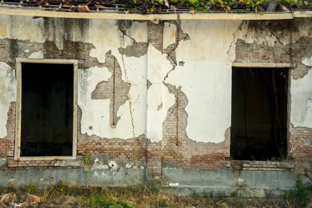 Image of abandoned house with two broken windows