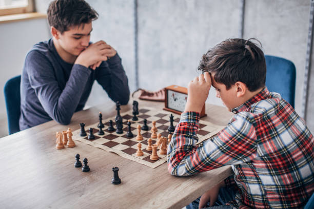 istock Two boys playing chess in school of chess 1182860403