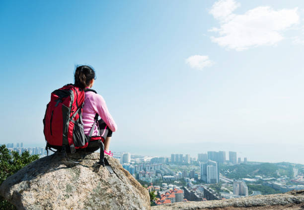 istock Woman backpacker enjoy the view on mountain peak 1182860674