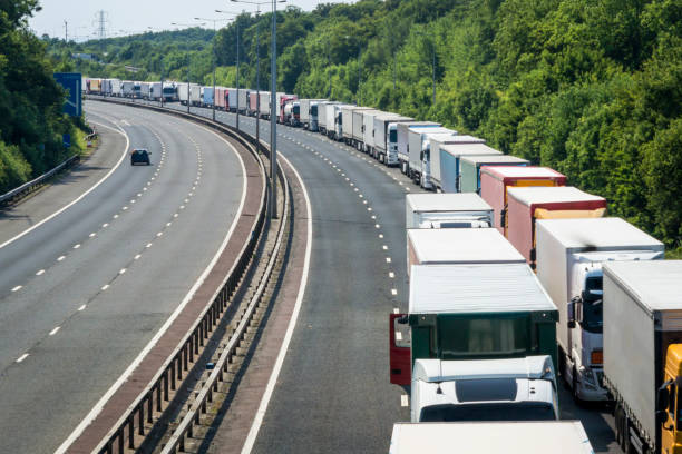 Lorries Parked on the M20 Motorway in Operation Stack Lorries queued when Operation Stack is in place on the M20 motorway in Kent striker stock pictures, royalty-free photos & images