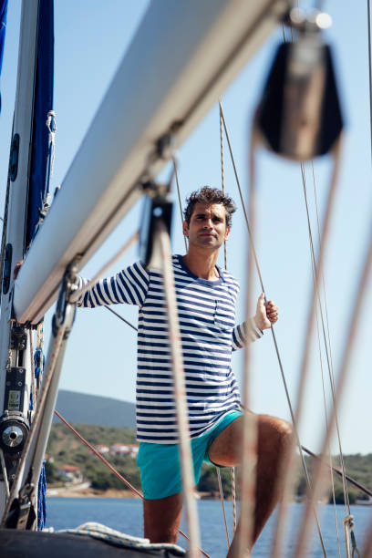 istock Young man on a sailboat 1182861590