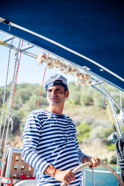 istock Handsome young man on a sailboat 1182861602