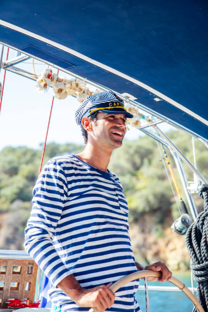 istock Handsome young man on a sailboat 1182861603