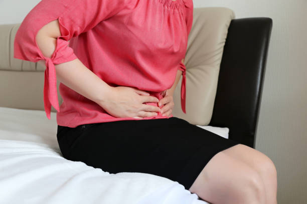 istock Woman suffering from stomach ache 1182862079