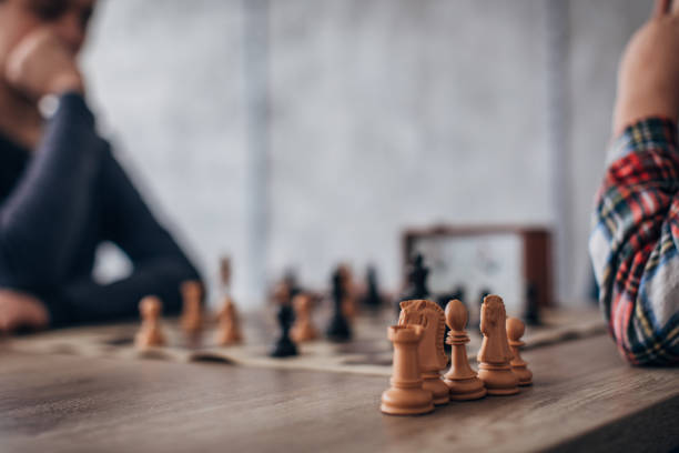 istock Two boys playing a game of chess 1182862100