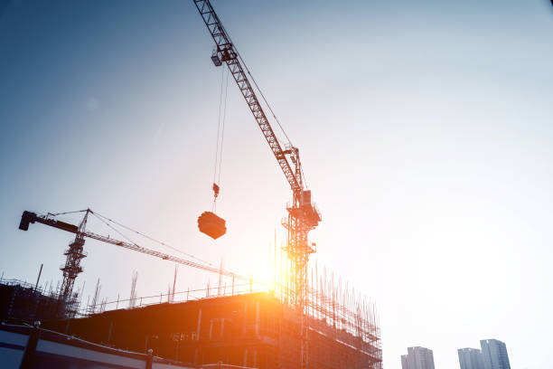 istock The crane is working at dusk 1182862142