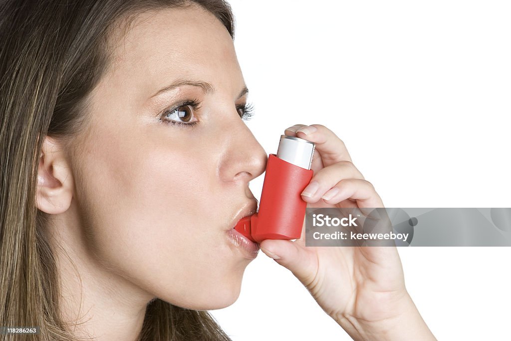 Woman Using Inhaler  Asthmatic Stock Photo
