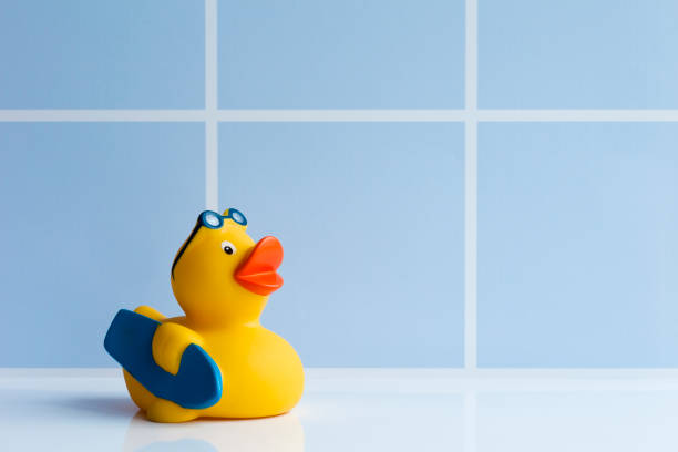 istock Yellow rubber duck with surfboard 1182863212