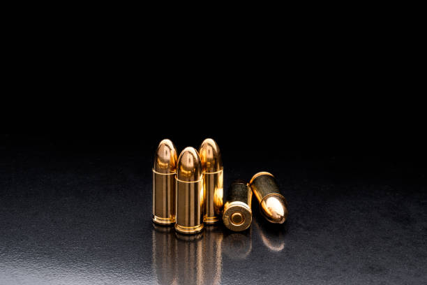istock Bullet isolated on black background with reflexion. Rifle bullets close-up on black back. Cartridges for rifle and carbine on a black. 1182863630