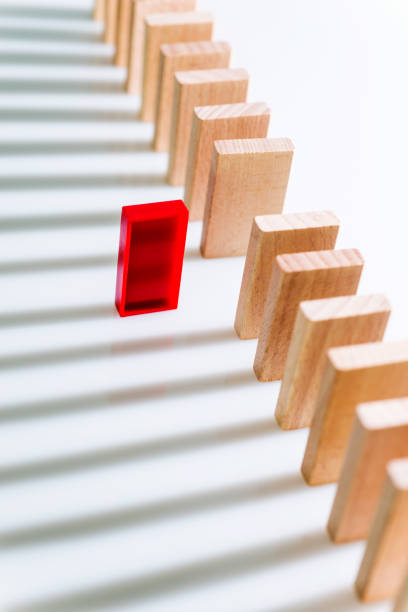 istock The red domino stands out 1182863788