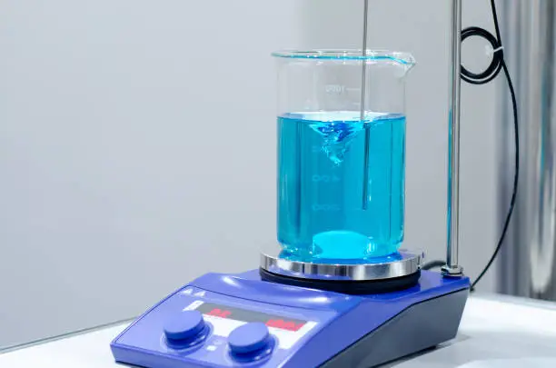 A magnetic stirrer or magnetic mixer is a laboratory device that employs a rotating magnetic field to cause a stir bar immersed in a liquid to spin very quickly, thus stirring it.