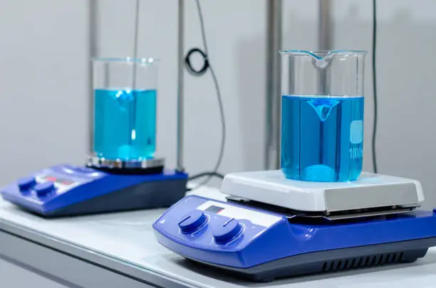 A magnetic stirrer or magnetic mixer is a laboratory device that employs a rotating magnetic field to cause a stir bar immersed in a liquid to spin very quickly, thus stirring it.