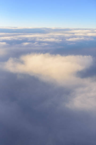 istock The blue skyline with cloudy in sunrise time, view from window on the plane. 1182867487