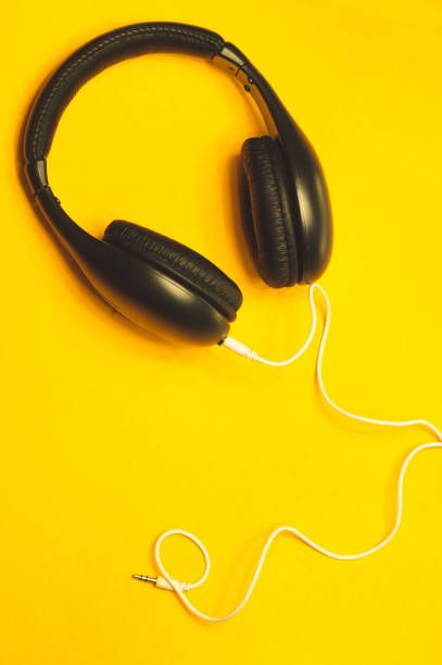 istock Headphones with white cable on a yellow background 1182869049