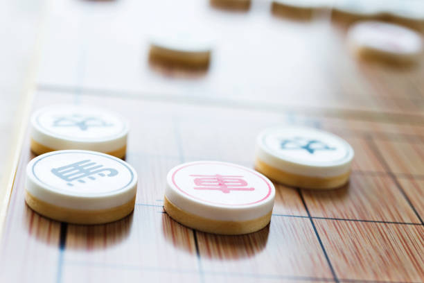istock Chinese chess pieces and chessboard 1182870434