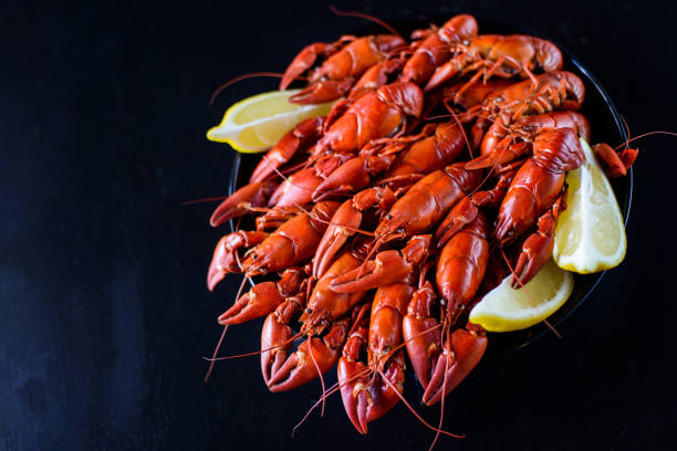 istock red crawfish with lemon on dark wood table 1182872093
