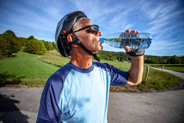 istock Senior Cycler Drinking Water From Water Bottle 1182872586