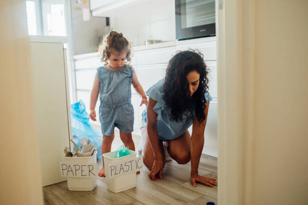 istock Mother and daughter recycling 1182872606