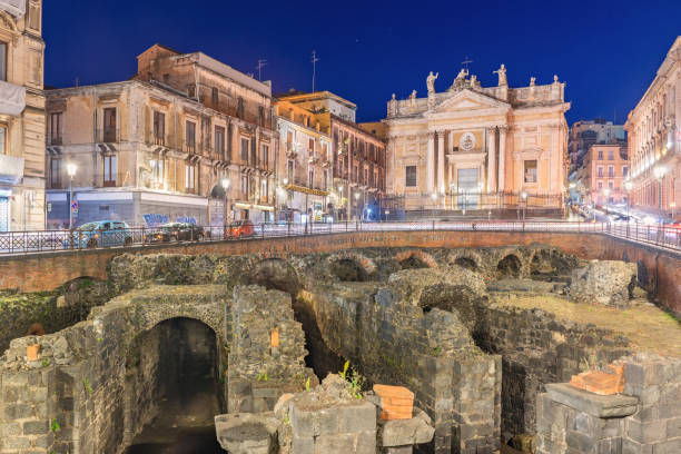 catania, italia: vista notturna dell'anfiteatro romano di catania, rovine di un antico teatro nella famosa città siciliana - catania sicily italy traffic foto e immagini stock