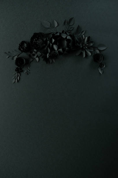 istock Black paper flowers on Black background. Cut from paper. 1182877007