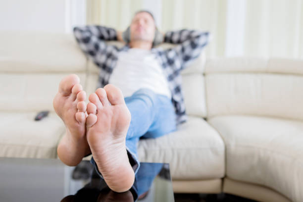istock Blurred background of young man relaxing on sofa 1182877139