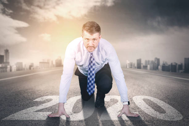 istock Caucasian businessman kneeling on numbers 2020 1182877662