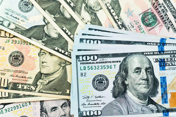 istock Group of dollar bills background 1182878332