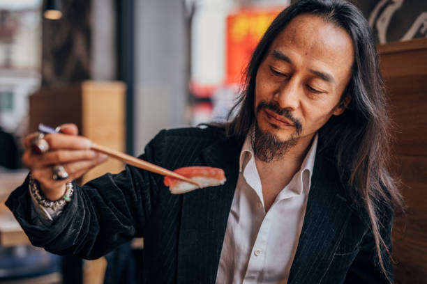istock Chinese gentleman loves sushi 1182880267