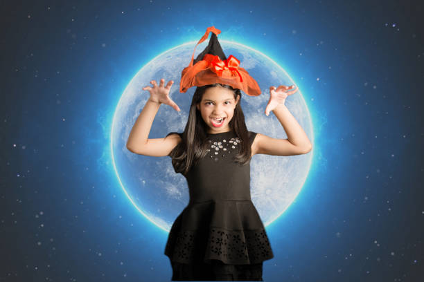 fantasy girl halloween witch hat scaring with moon background