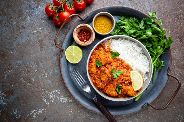 Chicken tikka masala Chicken meat with tikka masala sauce, spicy curry food in a bowl with rice and seasonings, top view healthy indian food stock pictures, royalty-free photos & images