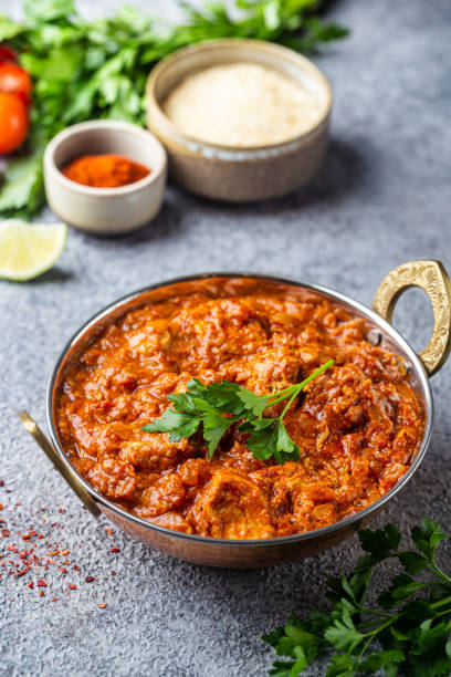 Chicken tikka masala Chicken meat with tikka masala sauce, spicy curry food in iron copper pot with seasonings tomato rice stock pictures, royalty-free photos & images
