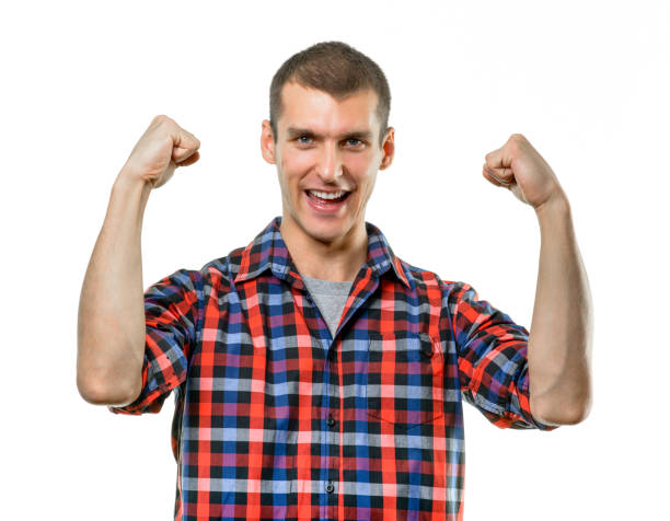 istock Casual young man shows the victory gesture 1182881431