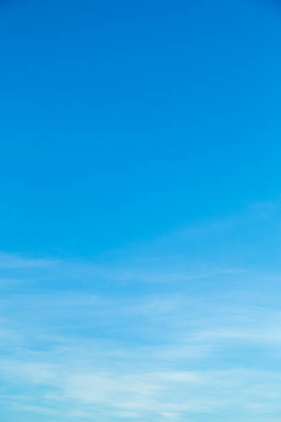 white clouds in blue sky. - blue vertical color image photography imagens e fotografias de stock