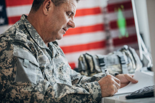 istock Solider writing on paper in the office 1182887003