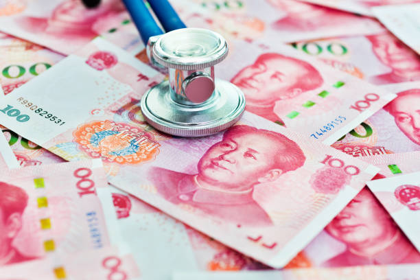 istock Stethoscope on top of Chinese yuan notes 1182888206