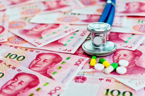 istock Stethoscope and pills on Chinese yuan notes 1182889728