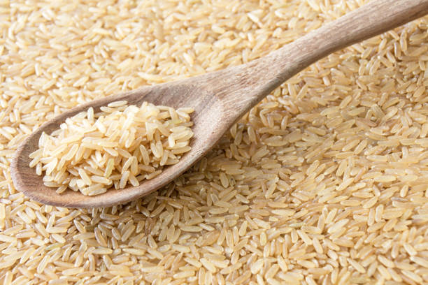 istock Rice whole grain on wooden spoon 1182890103