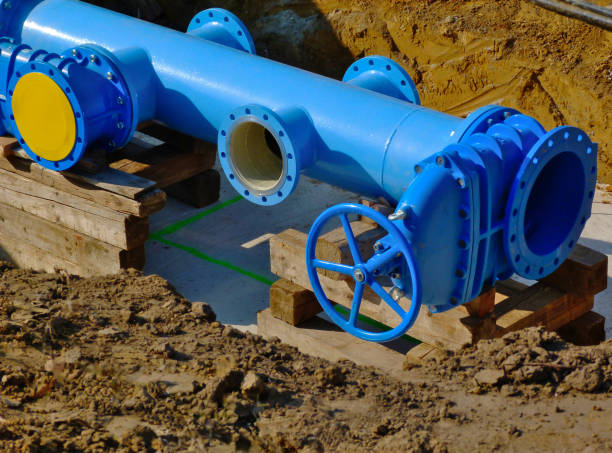 large diameter painted light blue steel water main pipe installation stock photo