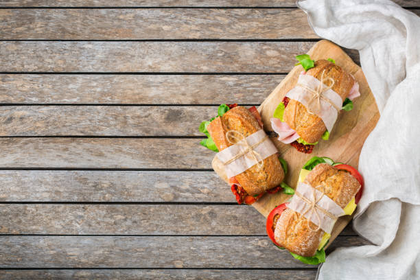 istock Fresh bread sandwich with ham, lettuce and tomato 1182901623