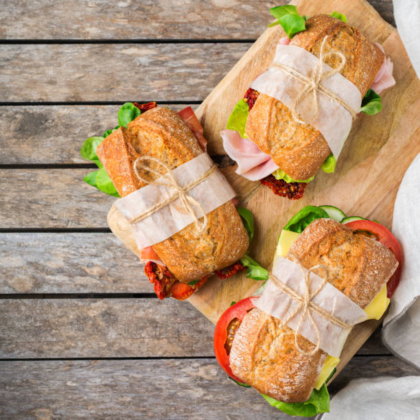 istock Fresh bread sandwich with ham, lettuce and tomato 1182901635