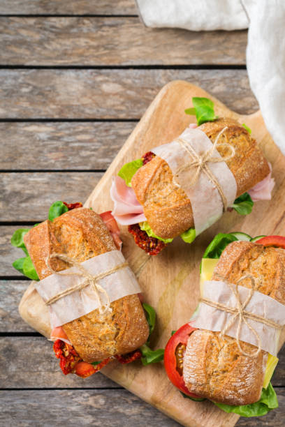 istock Fresh bread sandwich with ham, lettuce and tomato 1182901639