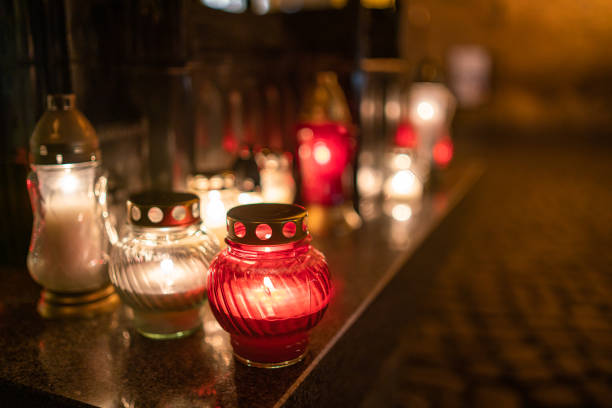 istock Jars with burning candles on stone surface at night 1182901642