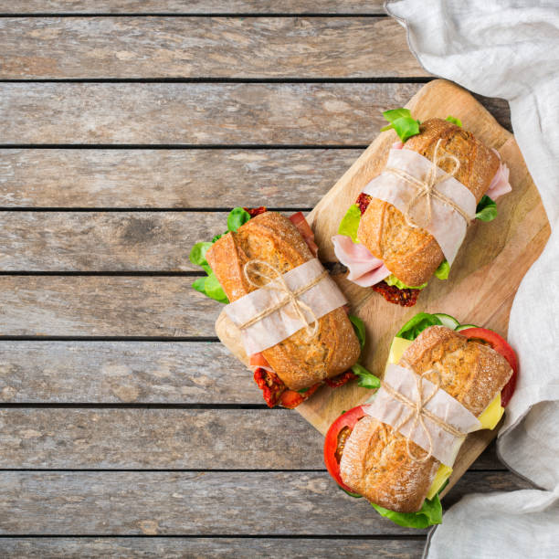 istock Fresh bread sandwich with ham, lettuce and tomato 1182901652