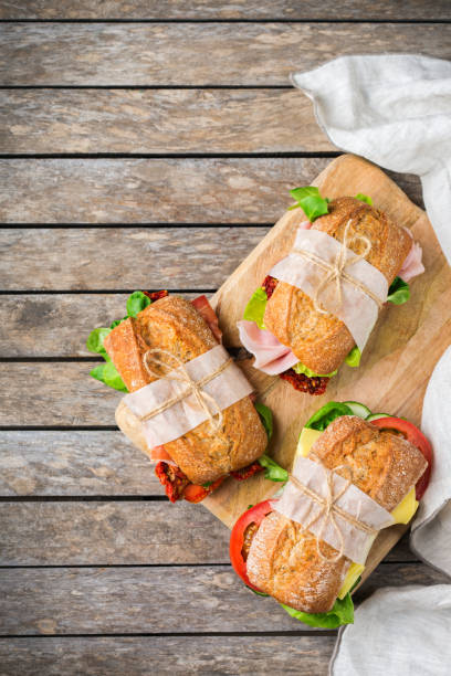 istock Fresh bread sandwich with ham, lettuce and tomato 1182901665