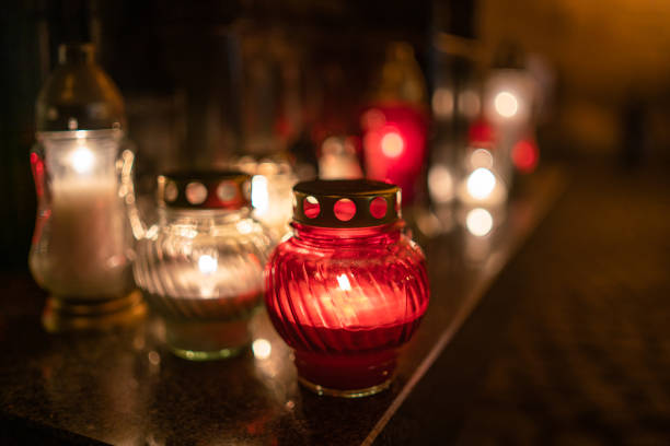 istock Jars with burning candles on stone surface at night 1182901760