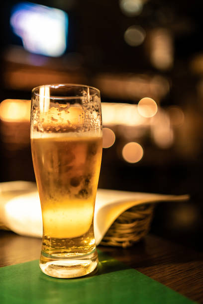 istock cold beer glass on bar or pub desk 1182902495
